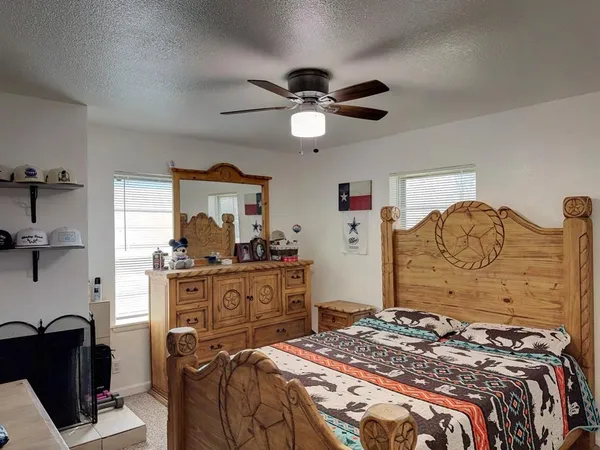 a bedroom with a bed dresser and a window