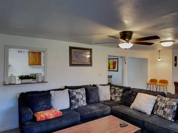 a living room with furniture and a lamp