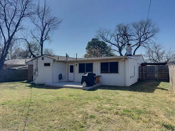 a view of a house with backyard and trees