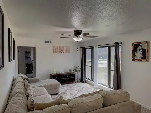 a living room with furniture and a large window