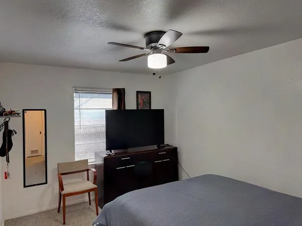 a bedroom with a bed and a flat screen tv