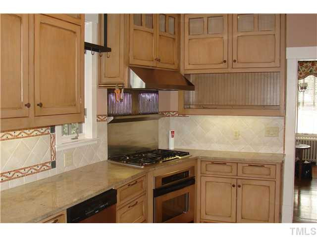303 Hillcrest Road Raleigh, NC 27605 - Photo 8 of 21 a kitchen with stainless steel appliances granite countertop a stove a sink and a cabinets