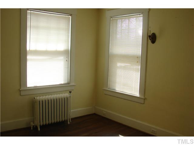 303 Hillcrest Road Raleigh, NC 27605 - Photo 10 of 21 a view of an empty room with a window