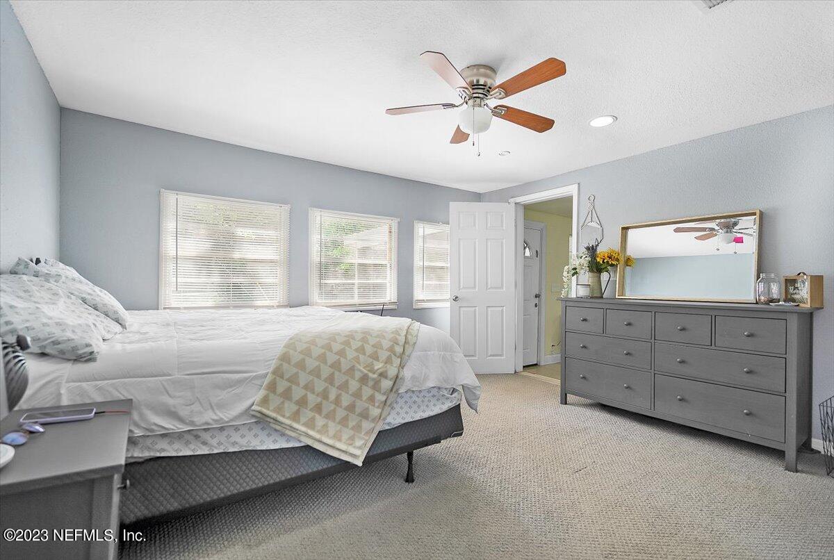 197 Lynn Street St. Augustine, FL 32084 - Photo 12 of 24 a spacious bedroom with a bed a window and dresser