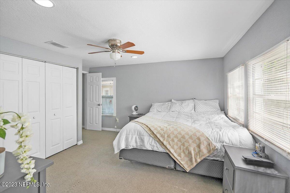 197 Lynn Street St. Augustine, FL 32084 - Photo 13 of 24 a bedroom with a bed and a chandelier