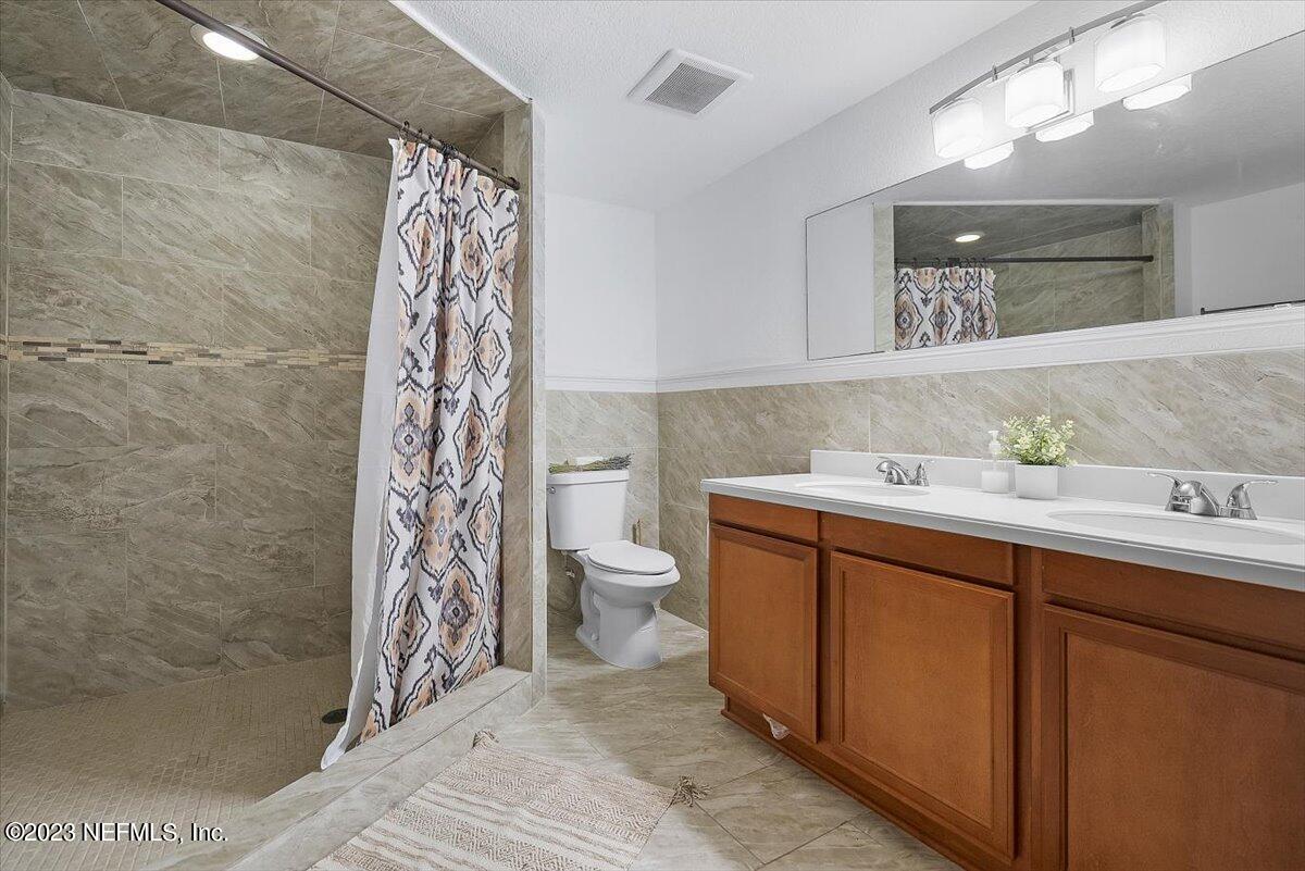 197 Lynn Street St. Augustine, FL 32084 - Photo 14 of 24 a bathroom with a sink a toilet and shower