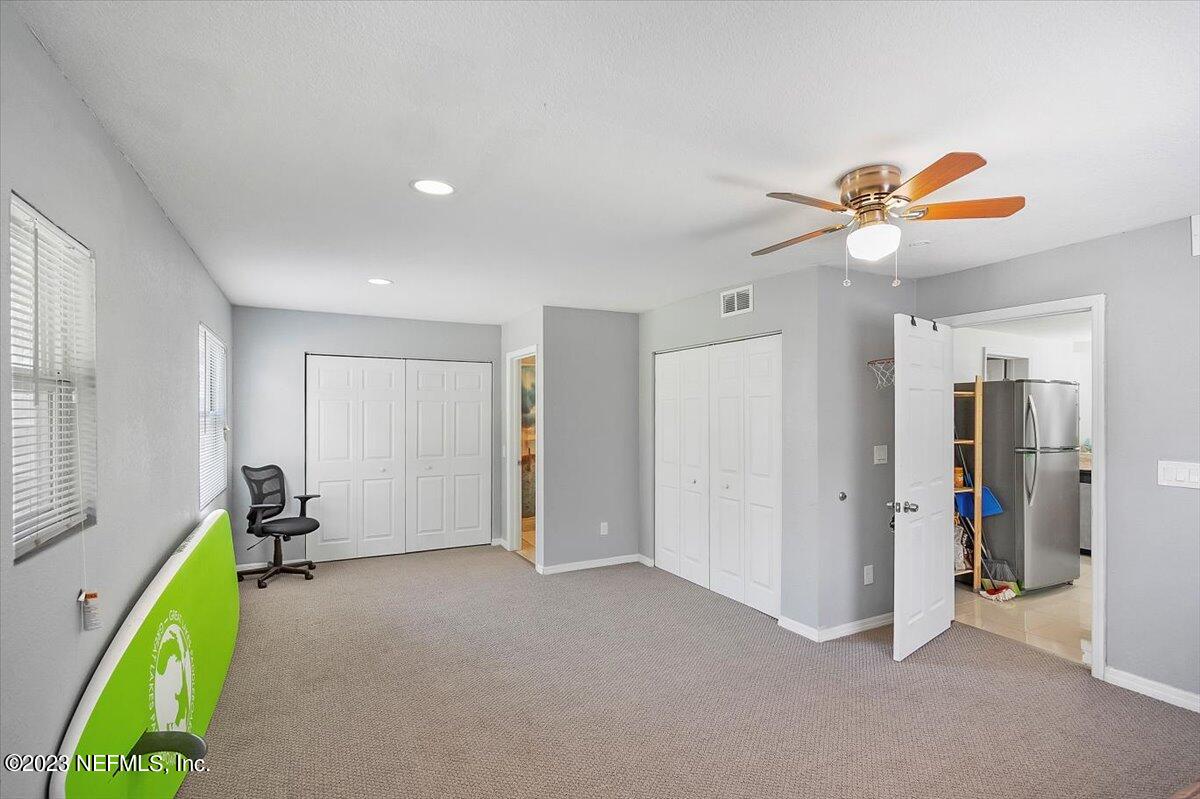 197 Lynn Street St. Augustine, FL 32084 - Photo 18 of 24 a view of a room with gym equipment and a chandelier