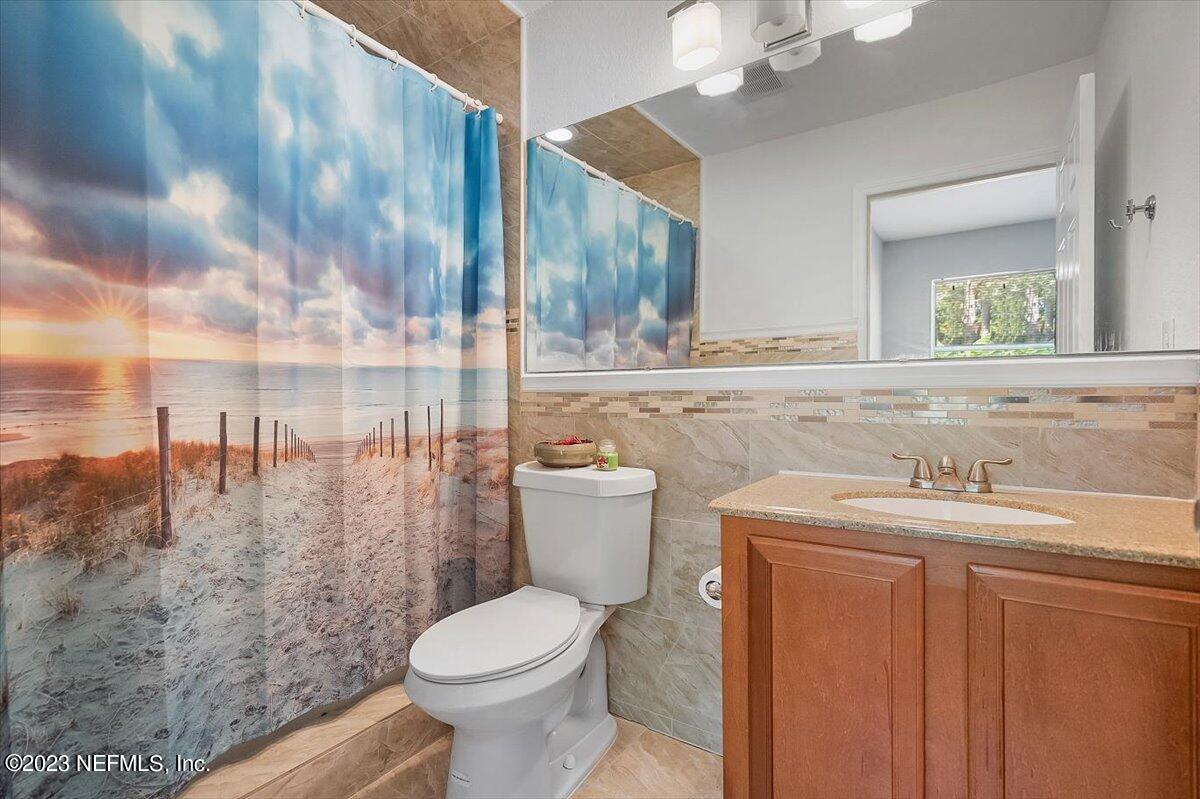 197 Lynn Street St. Augustine, FL 32084 - Photo 19 of 24 a bathroom with a granite countertop sink mirror vanity and toilet