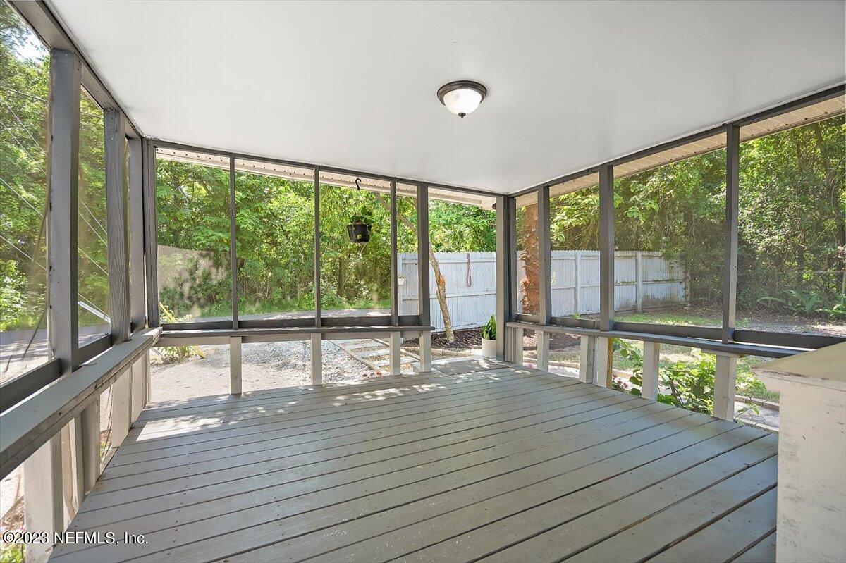 197 Lynn Street St. Augustine, FL 32084 - Photo 5 of 24 a view of an empty room with wooden floor and a large window