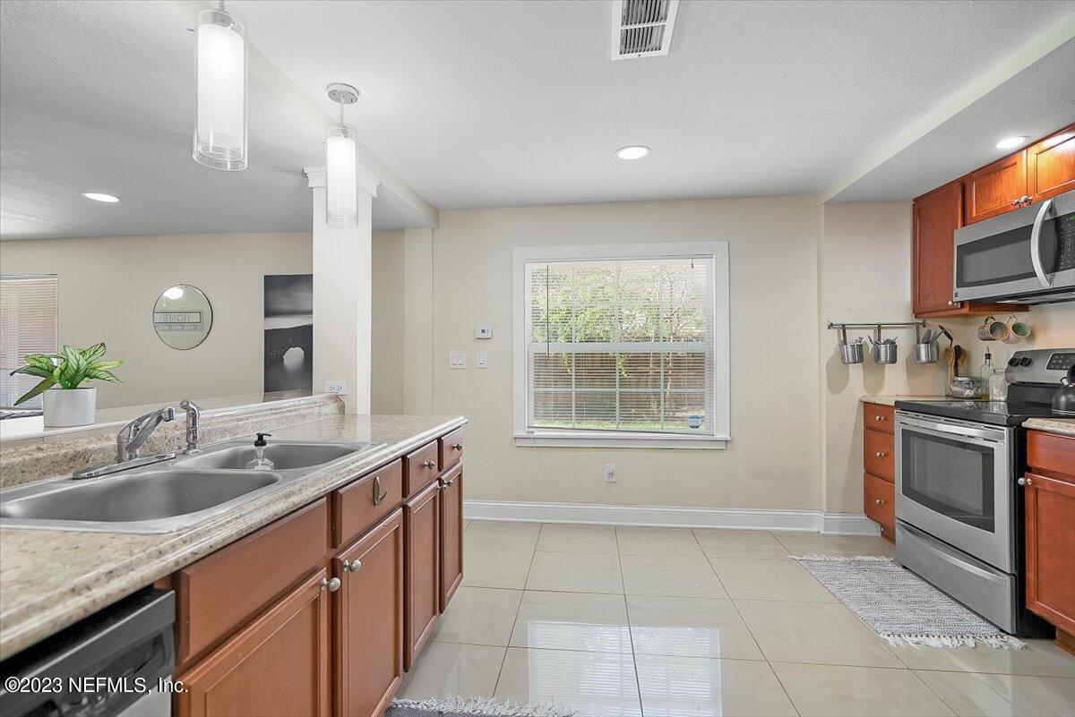 197 Lynn Street St. Augustine, FL 32084 - Photo 10 of 24 a kitchen with a sink stove and microwave