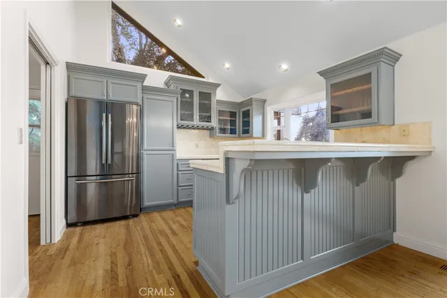 a kitchen with stainless steel appliances granite countertop a refrigerator a sink and a stove