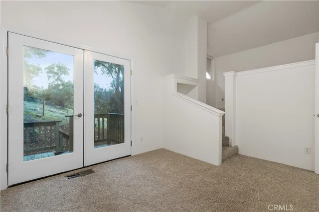 a view of empty room with floor to ceiling window and an entrance