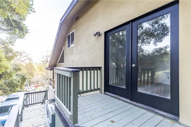 a view of a balcony with wooden floor and wooden fence