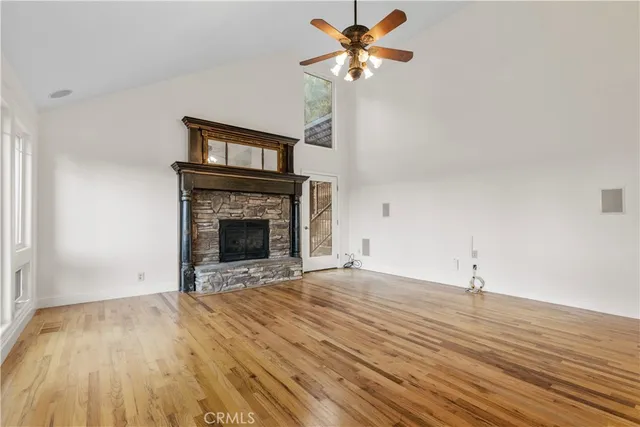 a view of an empty room with a fireplace and a window