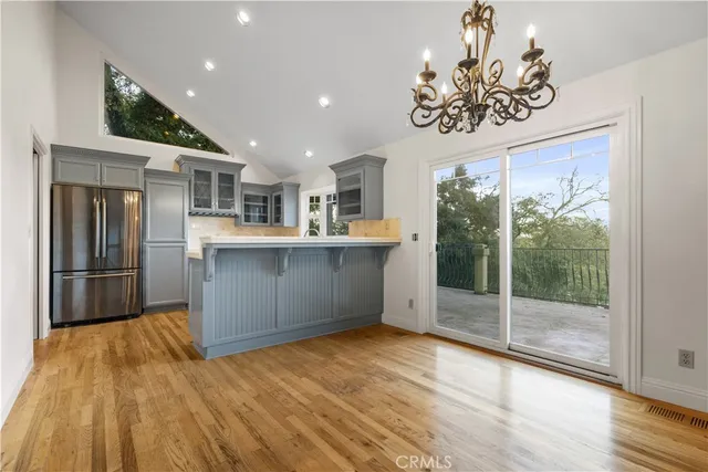 a kitchen with kitchen island a counter top space wooden floor and appliances