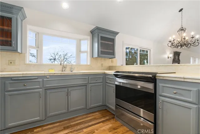 a kitchen with stainless steel appliances granite countertop a sink and cabinets