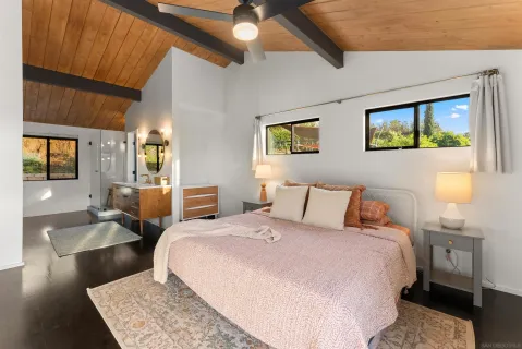 a bedroom with a large bed and a couch