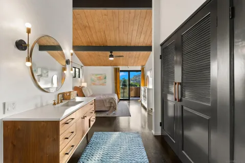 a bathroom with a sink a mirror and shower