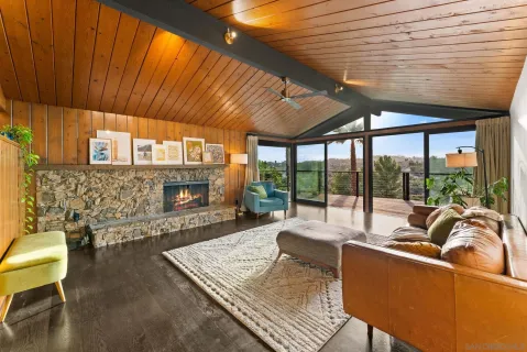 a living room with furniture a fireplace and a table
