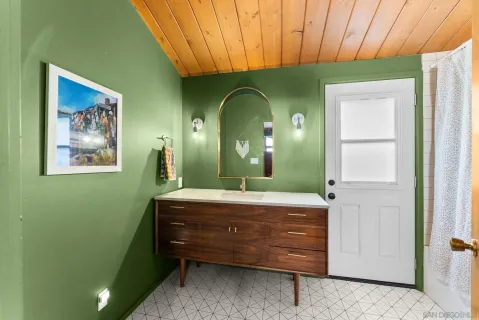 a room with a mirror sink and closet