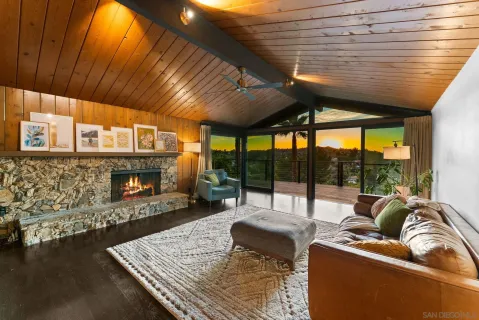 a living room with furniture a fireplace and a table