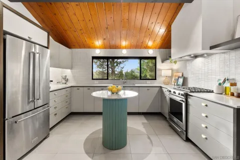 a large kitchen with a stove a sink dishwasher and a refrigerator