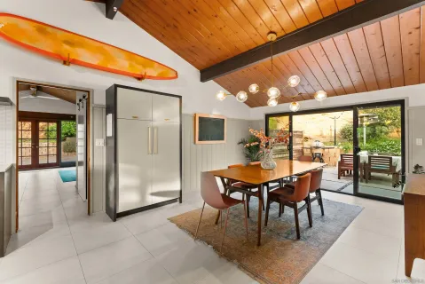 a dining room with furniture and wooden floor