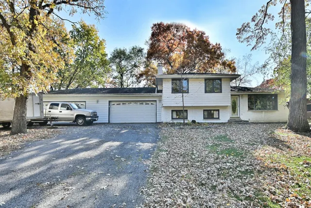a view of a house with a yard and garage