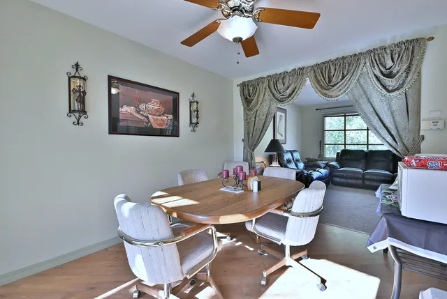 a view of a dining room with furniture a chandelier and wooden floor
