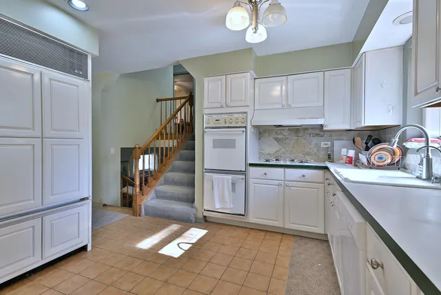 a kitchen with cabinets and window