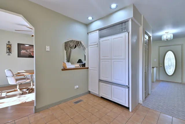 a view of a hallway to closet and wooden floor
