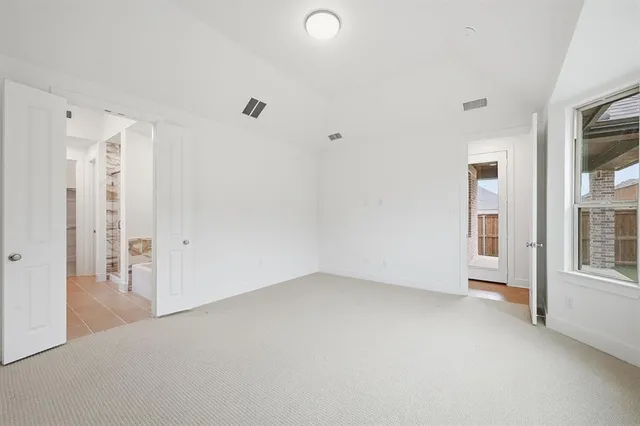 a spacious bathroom with a bathtub sink and mirror
