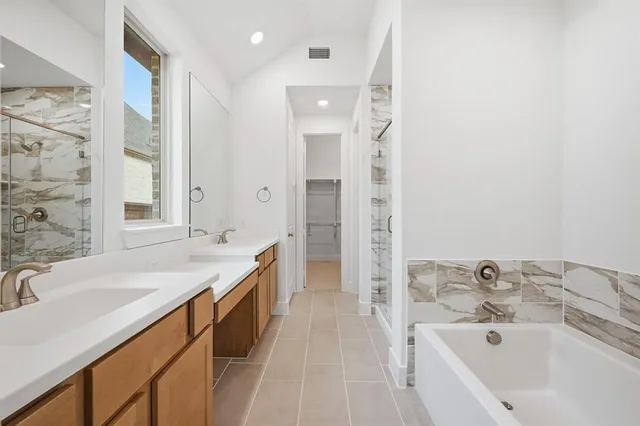 a bathroom with a bathtub and a shower