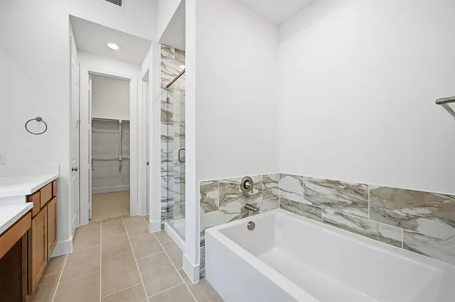 a bathroom with a bathtub and shower