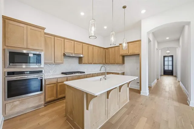 a kitchen with a sink stove and microwave