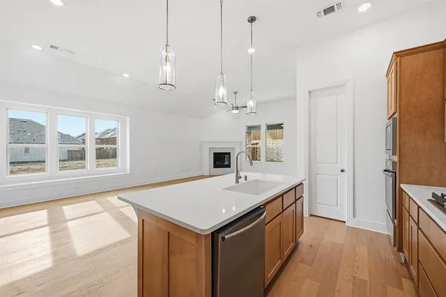 a kitchen with a sink a counter top space and a window
