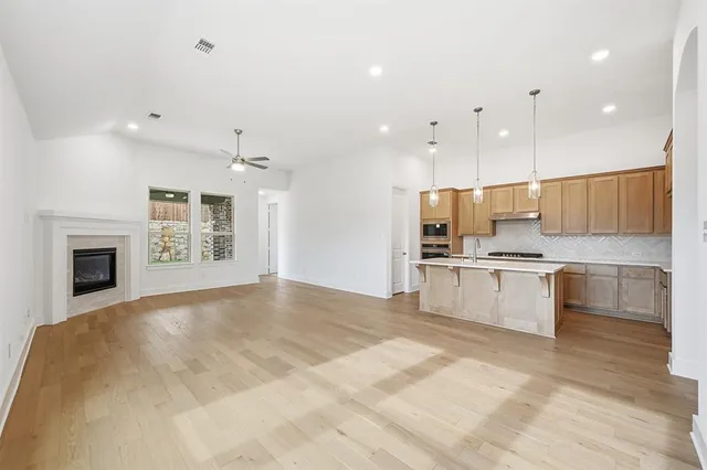 a large kitchen with kitchen island a sink stainless steel appliances and cabinets