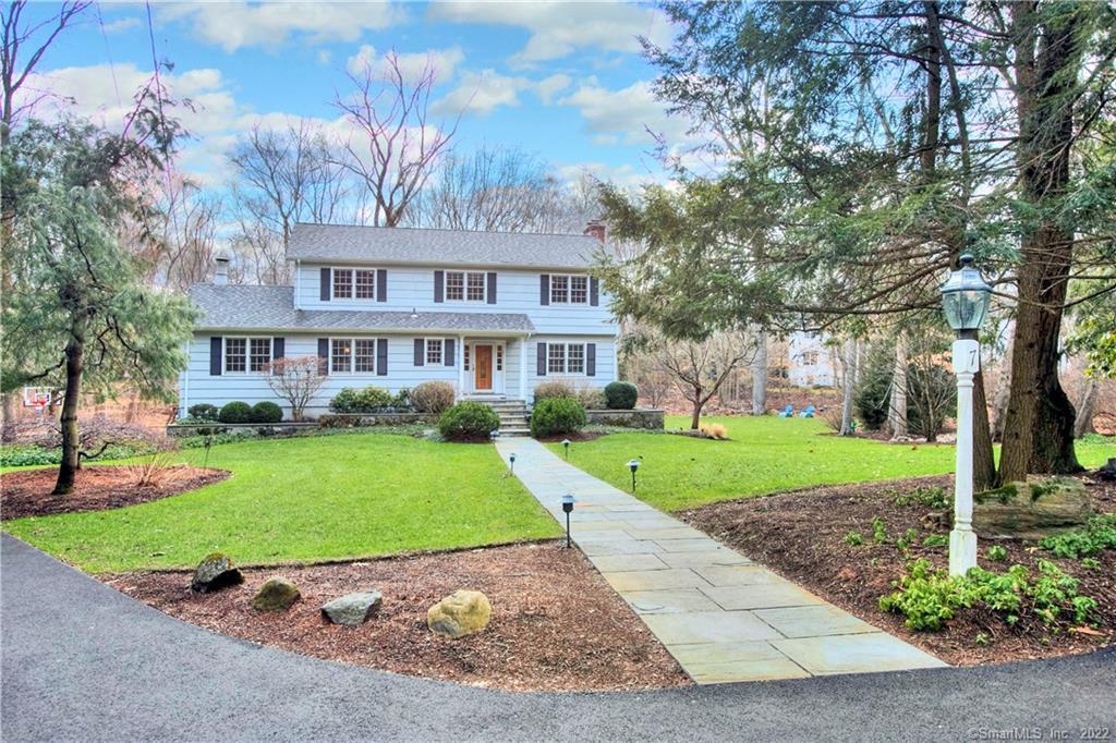 7 Rebel Road Westport, CT 06880 - Photo 1 of 1 a front view of a house with a yard and garage