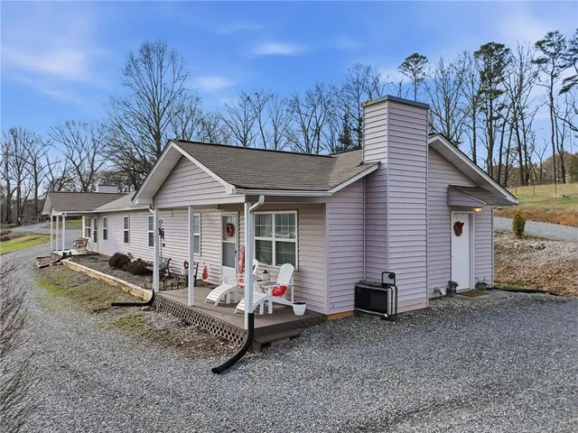 a view of a house with a yard and wooden fence