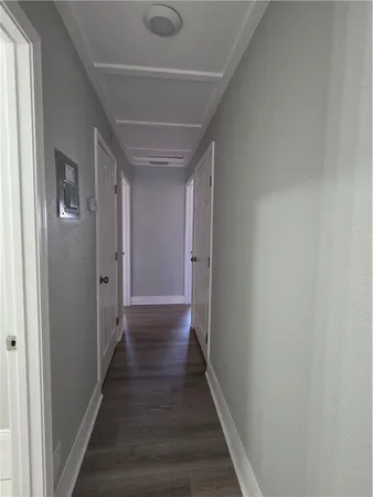 a view of a big room with wooden floor and a window