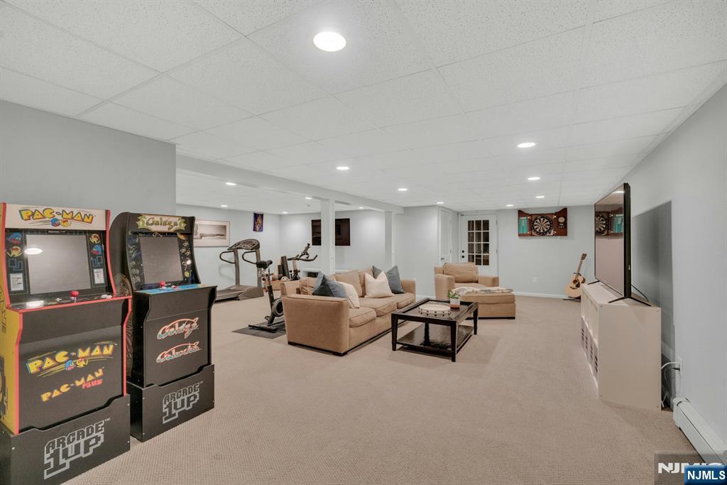 48 Hopper Farm Road Upper Saddle River, NJ 07458 - Photo 34 of 43 a living room with furniture and a flat screen tv