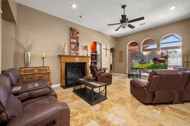 a living room with furniture a fireplace and a large window