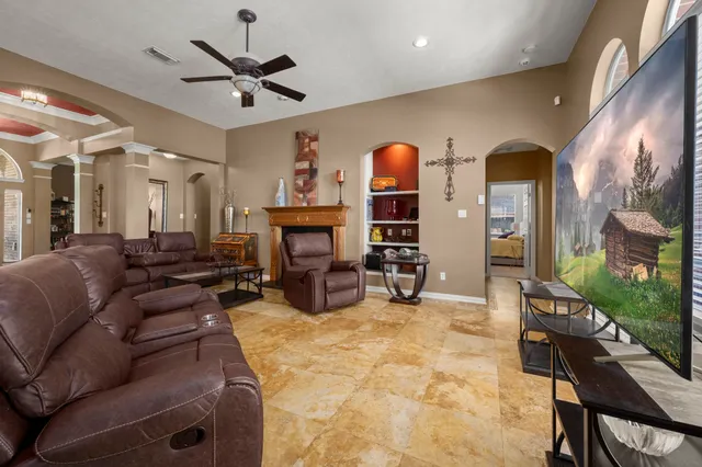 a living room with furniture a fireplace and a flat screen tv