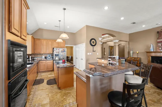 a kitchen with a sink appliances and cabinets