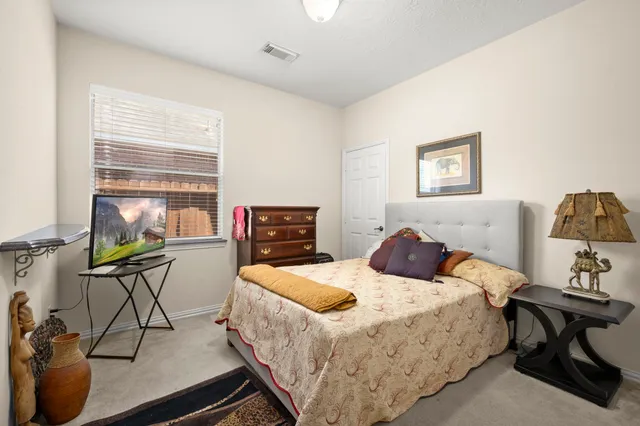 a bedroom with a bed and a table in it