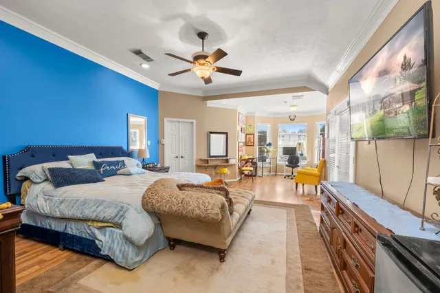 a spacious bedroom with a bed and a chandelier