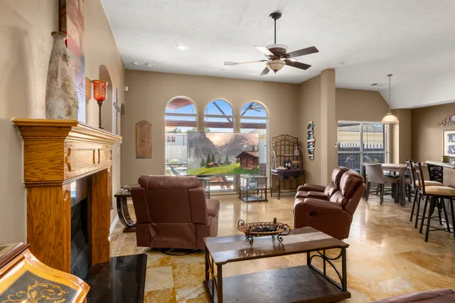 a living room with furniture and floor to ceiling windows