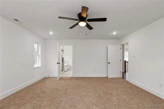 a view of empty room with ceiling fan
