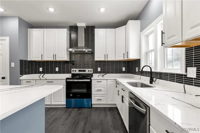 a kitchen with stainless steel appliances granite countertop a sink stove and cabinets
