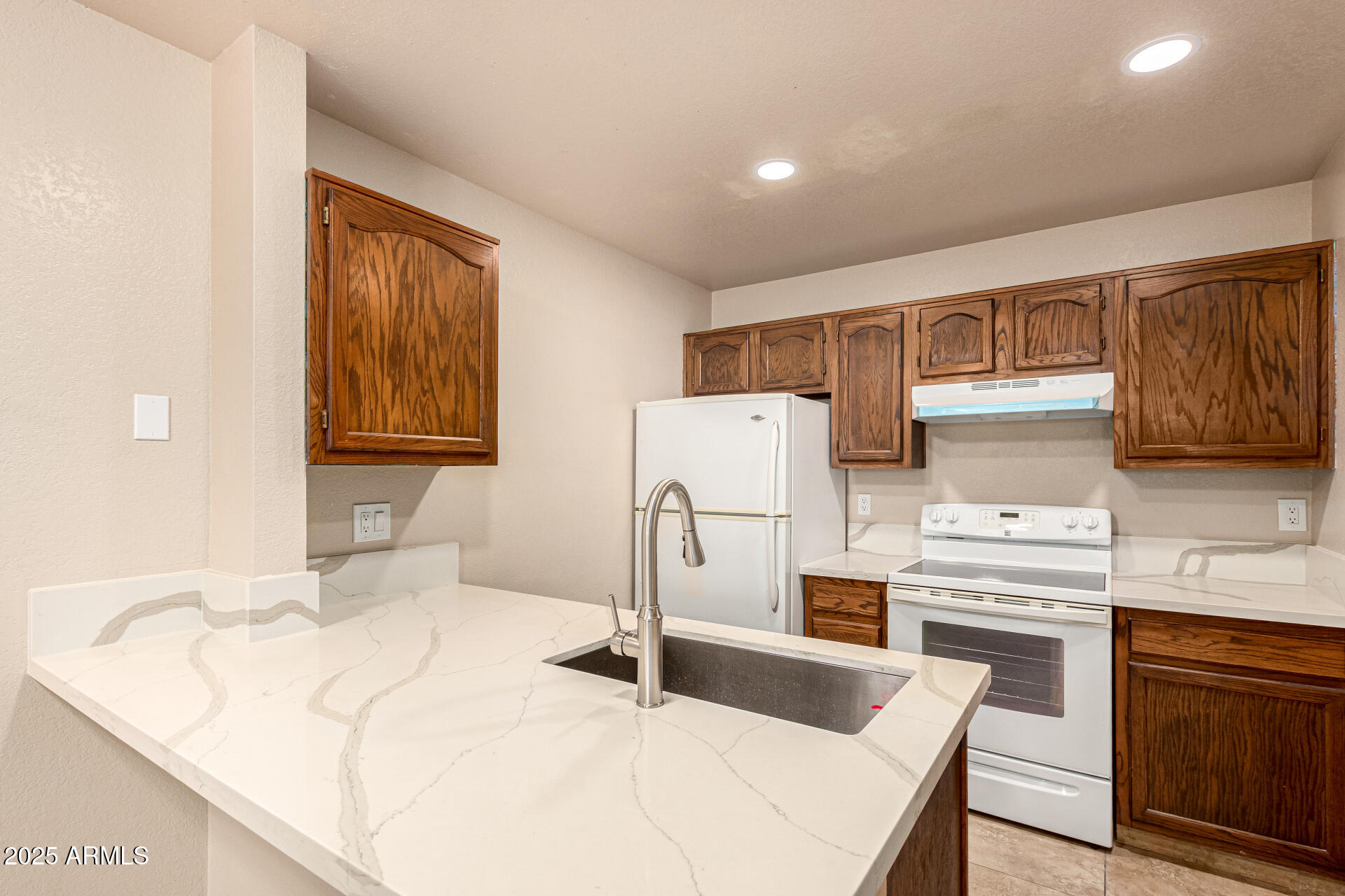510 North Alma School Road, Unit 159 Mesa, AZ 85201 - Photo 11 of 36 a kitchen with a sink a stove and refrigerator